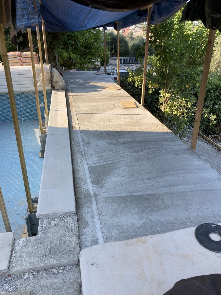 Completed swimming pool renovation with new terrace and fencing.